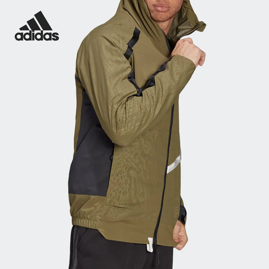 Person wearing a green and black Adidas jacket on a white background